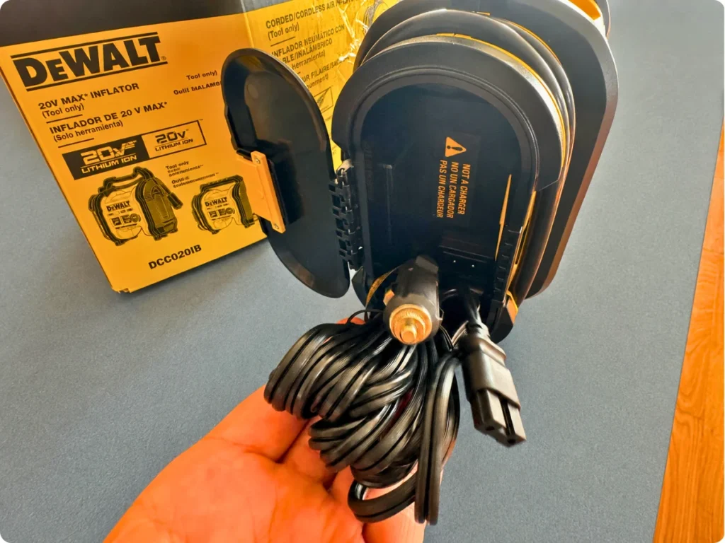 Rear power compartment of the DEWALT DCC020IB with the stored 12V cord